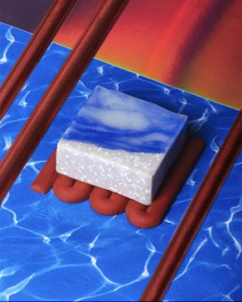 Hank Brussels Son of a Beach soap placed on a red soap dish, styled against a vibrant blue water pattern and gradient background.